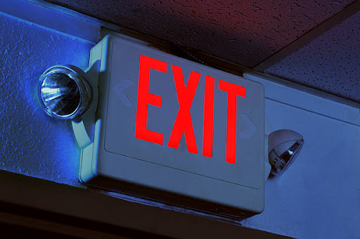 Exit sign illuminated in the dark